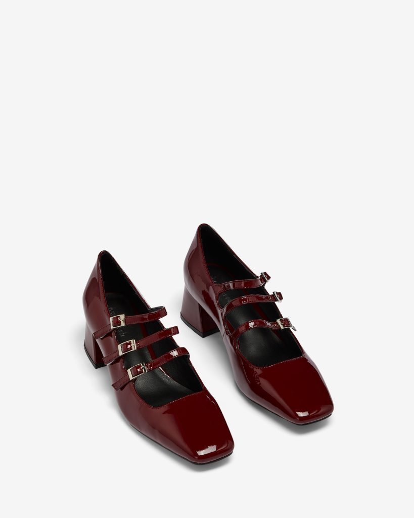 Glossy burgundy Mary Jane heels with triple straps and block heels on a white background