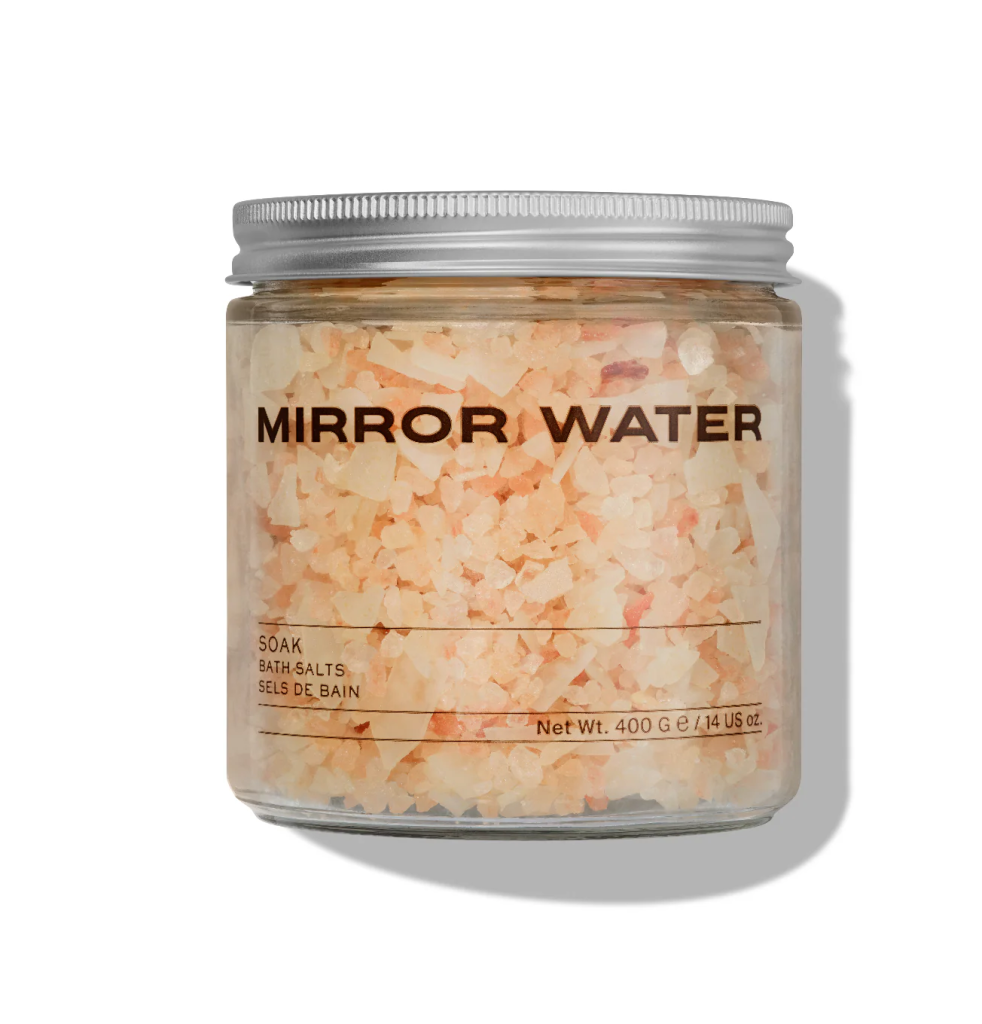 Jar of Mirror Water bath salts with a silver lid, labeled Soak, containing pink and white crystals, 400g