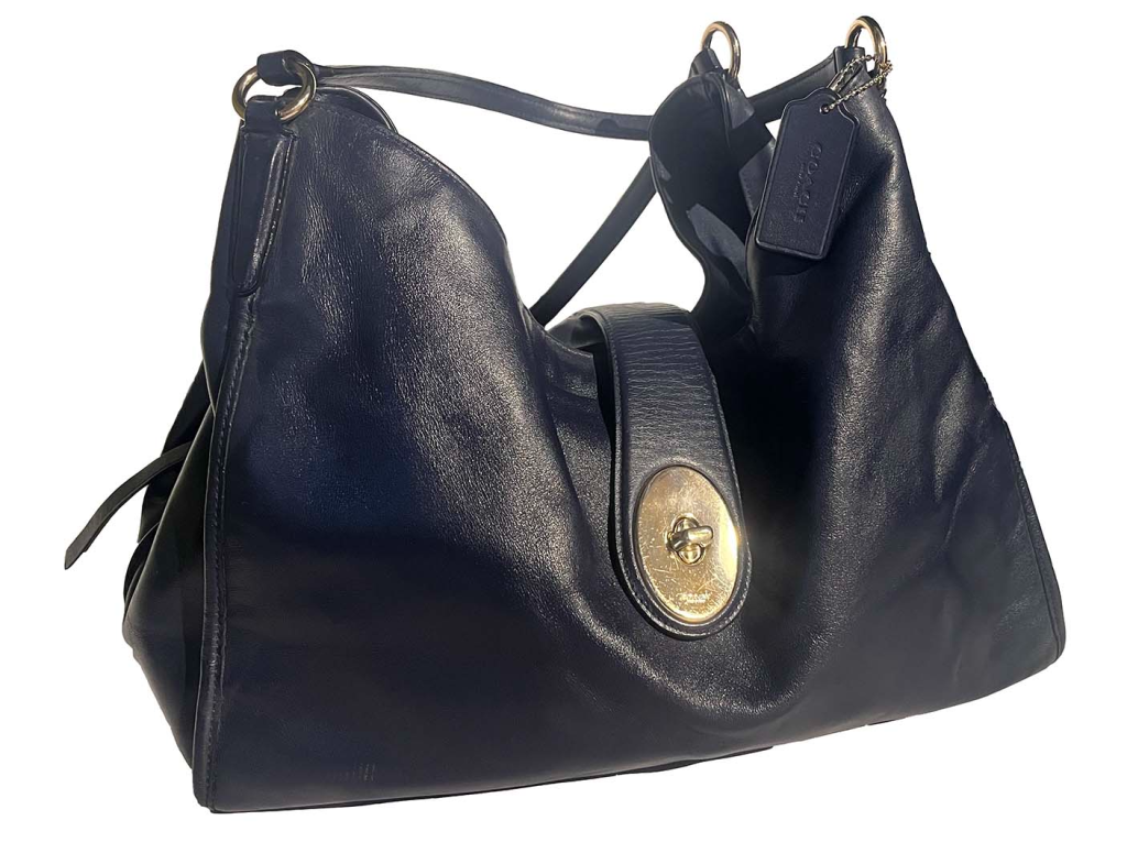 Luxurious black leather handbag with gold accents and a turn-lock closure, offering a stylish and practical accessory.