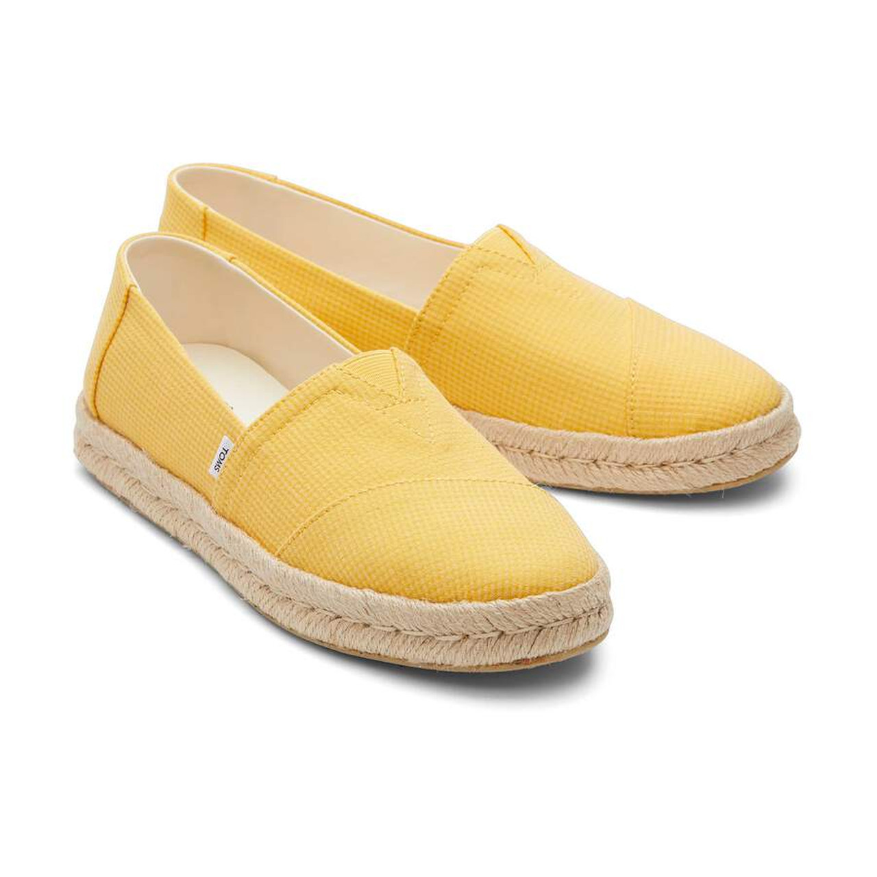 Yellow espadrille slip-ons with textured uppers and rope soles, perfect for casual summer style.