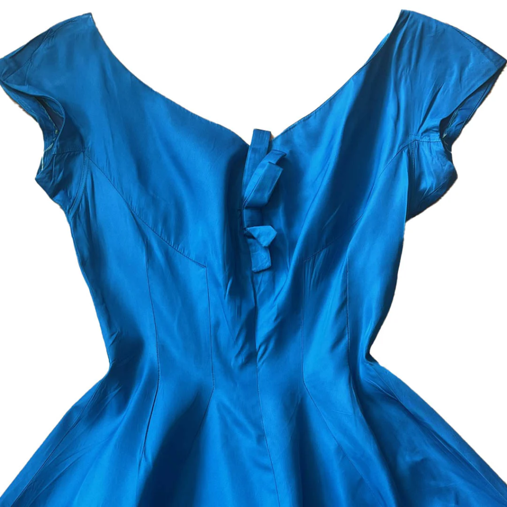 Elegant blue satin dress with cap sleeves and a bow at the back, showcasing a classic vintage style.